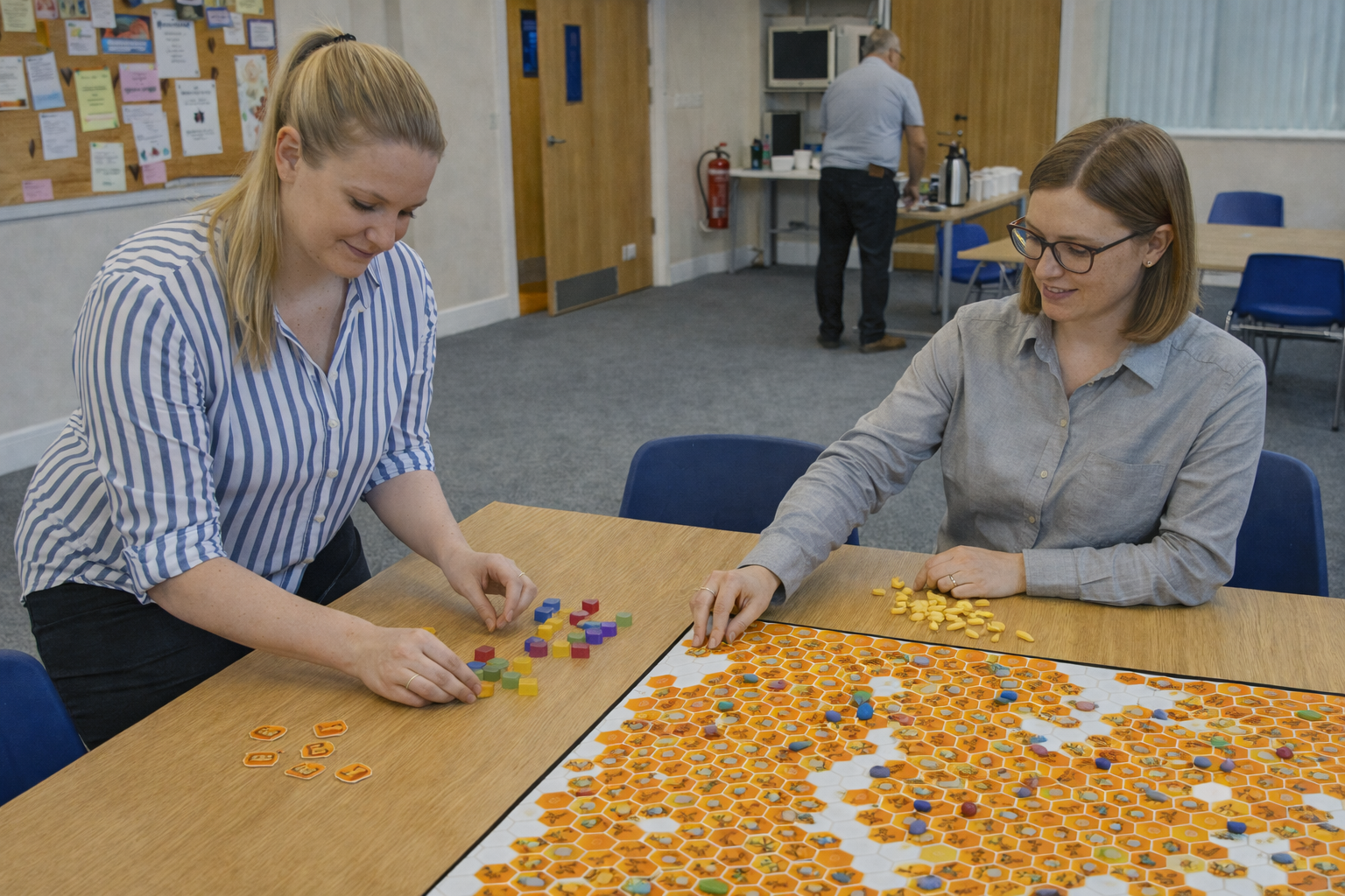 Bee The Change facilitator and researcher setting up the honeycomb board for a resident engagement session to capture voice and insight